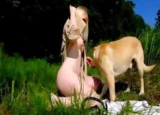 Blonde enjoys outdoor zoophilia by letting the dog lick her and smiff her ass